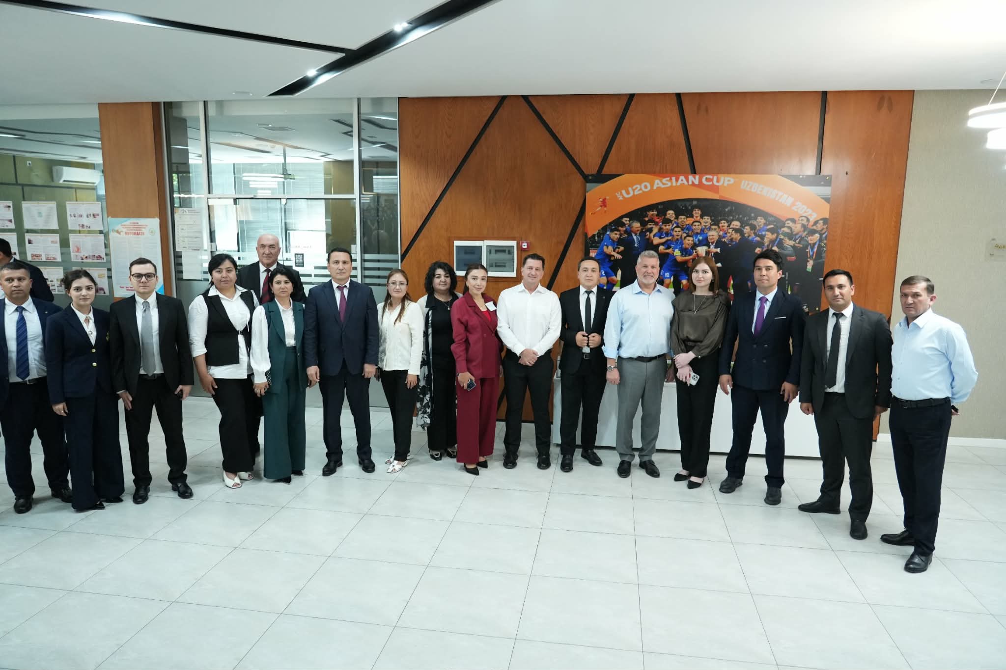 Participants gathered for a group photograph indoors.